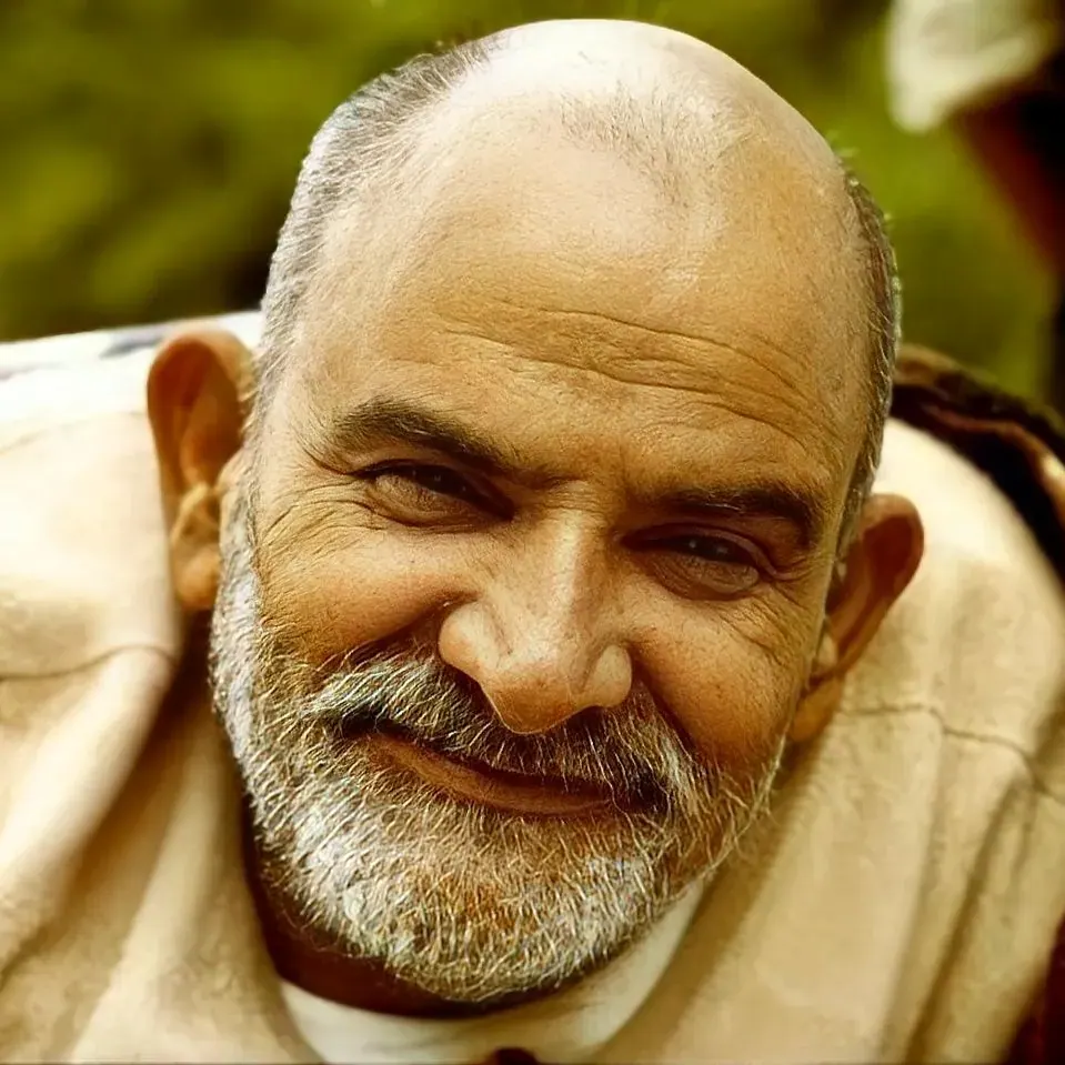 An elderly man smiling in warm natural sunlight